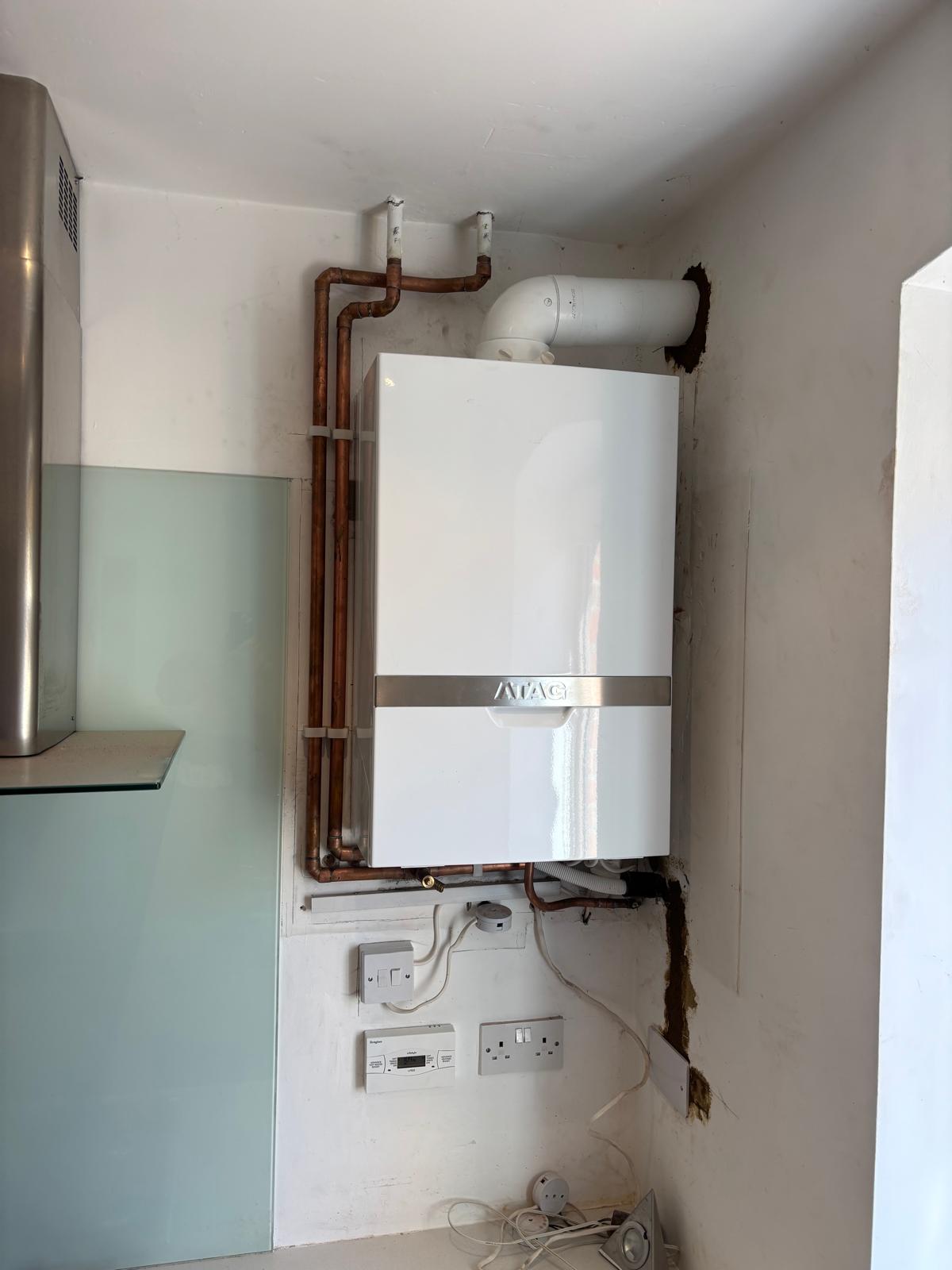 ATAG boiler installed in a kitchen corner with tidy copper piping